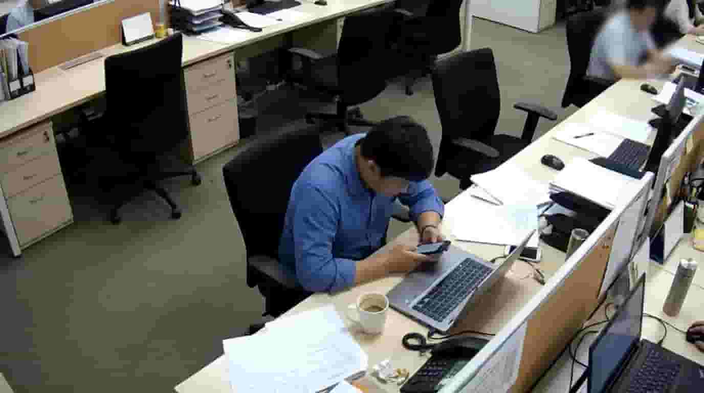 Employee sitting idle at desk low productivity